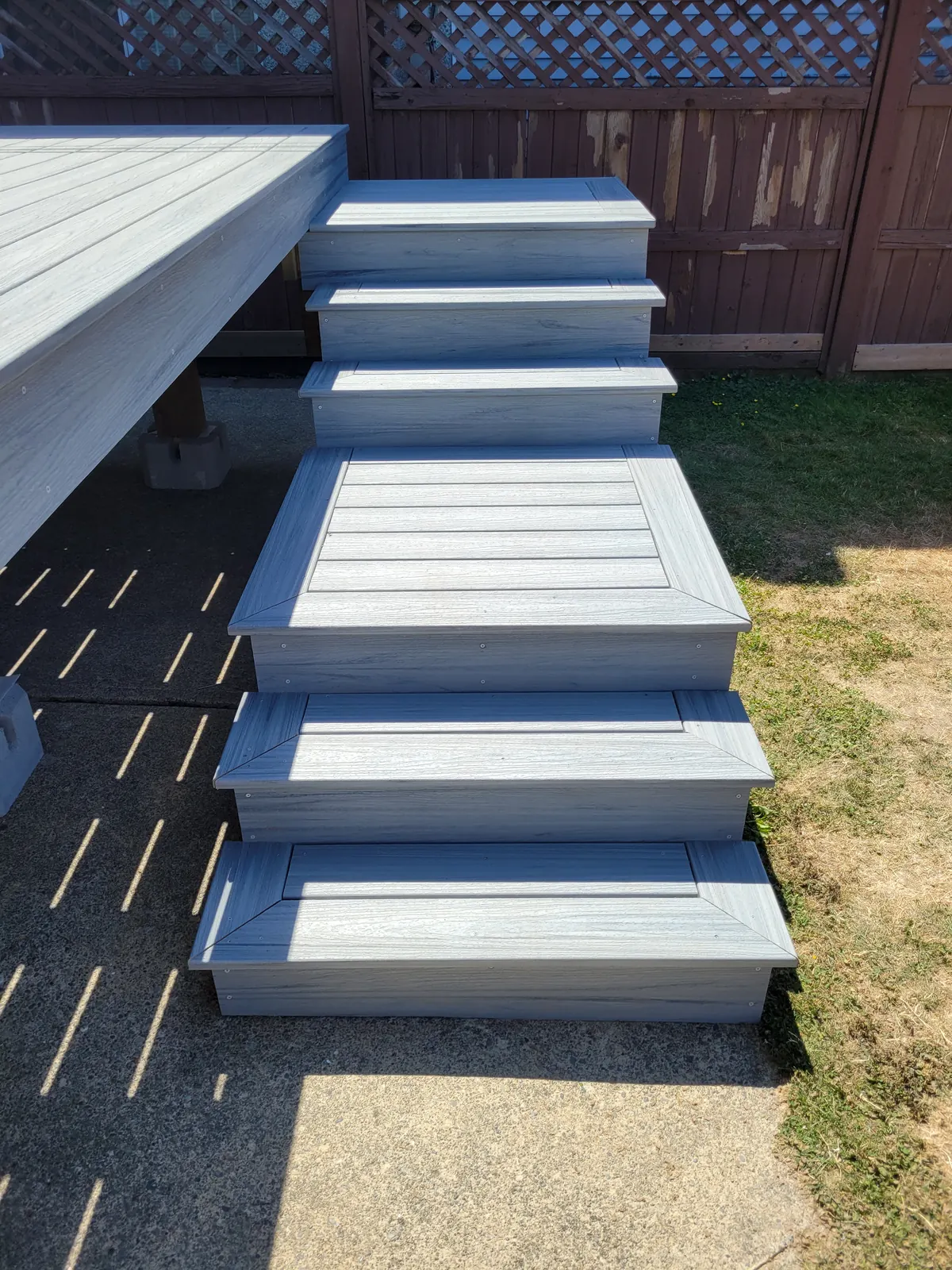 Composite deck stairs with mitred borders and a landing