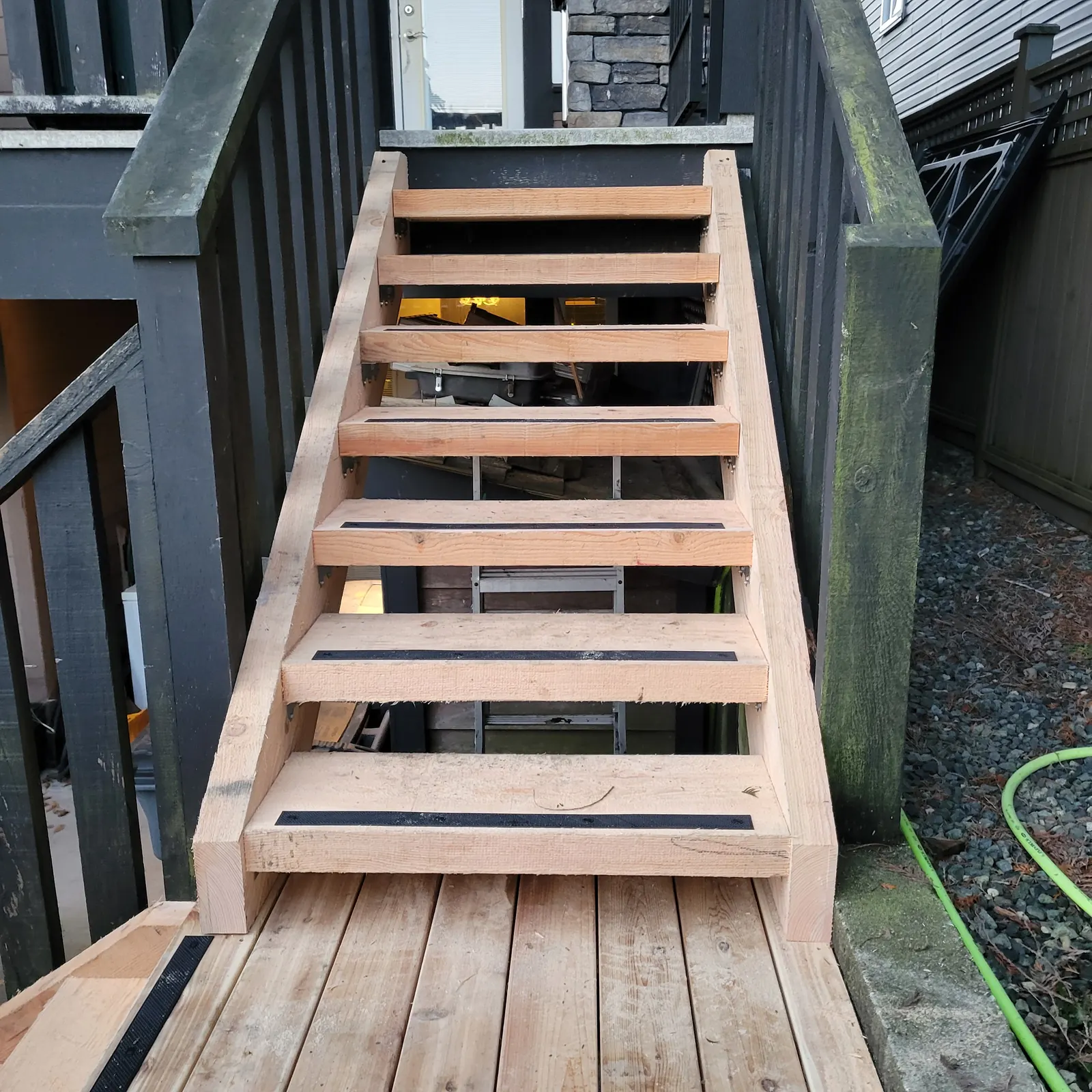Rebuilt wooden stairs with black non slip strips on each tread